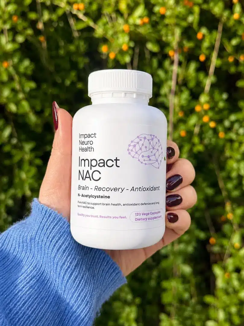 Impact NAC bottle held in hand outdoors